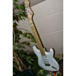 A COPY OF A FENDER STRATOCASTER GUITAR with a white over painted body, two humbers and one single