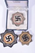 THREE GERMAN TUNIC BADGES, two badges are pin back and the third is cloth, the silver and gold