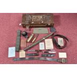 A QUANTITY OF MILITARY RELATED ITEMS, to include an ammo box, belts, WWII ephemera including pay and