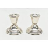 A PAIR OF SILVER CANDLESTICKS, dwarf candlesticks, tapering in form to the round stepped, weighted
