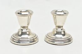 A PAIR OF SILVER CANDLESTICKS, dwarf candlesticks, tapering in form to the round stepped, weighted