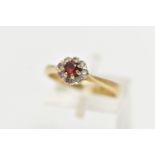 A 9CT GOLD GARNET AND PASTE CLUSTER RING, the principal garnet, within a colourless paste