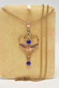 A YELLOW METAL LAVALIER PENDANT NECKLACE, the rose tone openwork floral pendant, set with two blue