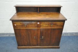 AN OAK SIDEBOARD, with a raised back, two drawers, over double cupboard doors, width 112cm x depth