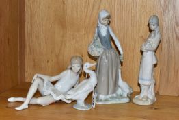 THREE FIGURINES INCLUDING NAO, AND A LLADRO DUCK, comprising Nao 'Reclining Ballerina' and 'Girl