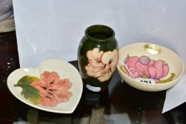 THREE PIECES OF MOORCROFT POTTERY, comprising a footed bowl decorated in the Magnolia pattern on a