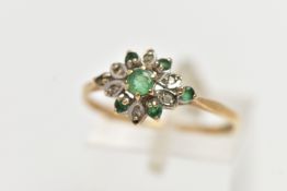 A 9CT YELLOW GOLD, EMERALD AND DIAMOND CLUSTER RING, the cluster of a flower shape, set with a
