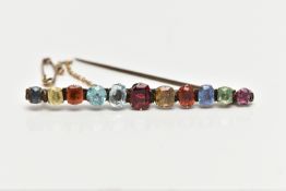 A YELLOW METAL MULTI GEMSTONE BAR BROOCH, designed with a row of vary cut gemstones, each claw