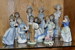 A GROUP OF ELEVEN NAO FIGURINES OF CHILDREN, to include a girl with puppy, a boy holding a