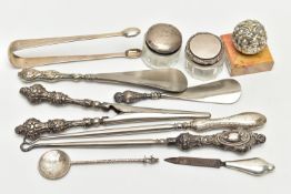 ELEVEN SILVER NOVELTIES, mainly early 20th century pieces, to include sugar tongs, two button