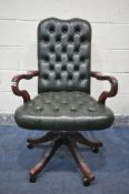 A GEORGIAN STYLE MAHOGANY SWIVEL OFFICE CHAIR, with open armrests and green buttoned leather (