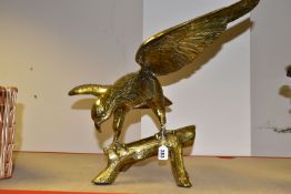 A LARGE, HEAVY BRASS EAGLE PERCHED ON A BRANCH, wings spread, height 44cm to tip of wing (1) (