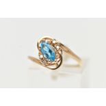 A TOPAZ AND DIAMOND DRESS RING, a marquise cut topaz accented with four round brilliant diamonds,