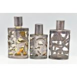 THREE MEXICAN SCENT BOTTLES, the glass bottles with pierced foliate designed cases, all stamped