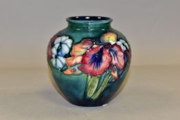A MOORCROFT POTTERY 'ORCHID' PATTERN VASE, of squat form, tube lined with purple and pale yellow