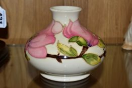 A MOORCROFT POTTERY MAGNOLIA VASE, of squat form, tube lined with pink Magnolia on a cream ground,