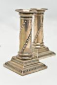 A PAIR OF CANDLE STICKS, Corinthian candlesticks, on square stepped bases (one with a weighted