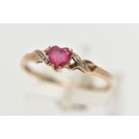 A 9CT YELLOW GOLD , RUBY AND DIAMOND RING, designed with a heart cut ruby, four claw set between