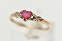 A 9CT YELLOW GOLD , RUBY AND DIAMOND RING, designed with a heart cut ruby, four claw set between