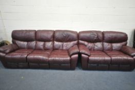 A RED LEATHER RECLINING SOFA SUITE, comprising an electric three seater sofa, and a manual reclining