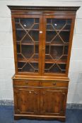 A YEWWOOD TWO DOOR GLAZED BOOKCASE, with two drawers, over double cupboard doors, width 92cm x depth