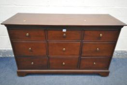 A MCDONAGH MAHOGANY SIDEBOARD, with nine drawers, on casters, length 127cm x depth 46cm x height,