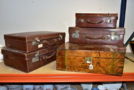 A COLLECTION OF FIVE BROWN VINTAGE SUITCASES AND A WOODEN WRITING SLOPE, comprising five 1950's