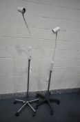 THREE BRANDON ADJUSTABLE MEDICAL LAMPS, on casters, and a floor lamp (4)