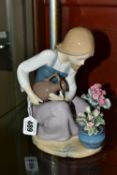 A LLADRO FIGURE 'WATERING THE FLOWER-POTS' NO 1376, sculpted by Juan Huerta, issued 1978-1990,