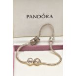 A PANDORA CHARM BRACELET, suspending four charms including a spherical charm inlaid with mother of