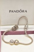 A PANDORA CHARM BRACELET, suspending four charms including a spherical charm inlaid with mother of