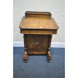 A MID TO LATE VICTORIAN WALNUT DAVENPORT, the top with hinged desk organiser, above a slopped lid,