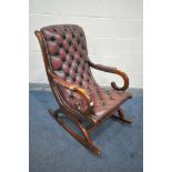 A MAHOGANY FRAMED OXBLOOD LEATHER SLIPPER ROCKING CHAIR (condition:-leather worn at seat, frame with