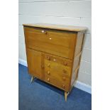 AN ERCOL ELM AND BEECH COCKTAIL CABINET, with a single fall door, enclosing a single shelf, above