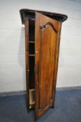 AN ANTIQUE FRUITWOOD SINGLE DOOR ARMOIRE, with an overhanging cornice, width 89cm x depth 76cm x