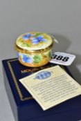 A BOXED MOORCROFT ENAMELS TRINKET BOX, of circular form, decorated with violets on a pale yellow
