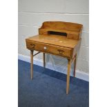 AN ERCOL ELM AND BEECH WRITING DESK, with a raised back with shelving and two drawers, above a
