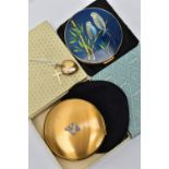 TWO YELLOW METAL PENDANTS AND COMPACTS, the first a heart shaped locket, stamped 9ct front and back,