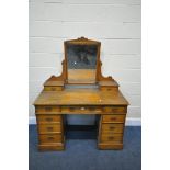 AN EDWARDIAN ASH PEDESTAL DRESSING TABLE, with a single swing mirror, and an arrangement of eleven
