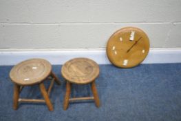 AN ELM CIRCULAR WALL CLOCK, with four plastic faces at every quarter point, along with a pair of