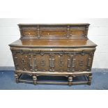 AN EARLY TO MID 20TH CENTURY CARVED OAK SIDEBOARD, with a raised back, over a base with three
