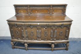 AN EARLY TO MID 20TH CENTURY CARVED OAK SIDEBOARD, with a raised back, over a base with three
