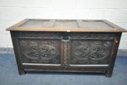 A GEORGIAN CARVED OAK PANELLED COFFER, width 135cm x depth 62cm x height 68cm (condition - later cut
