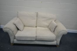 A BEIGE UPHOLSTERED TWO SEATER SOFA, length 183cm (condition - fire regulations label ripped off