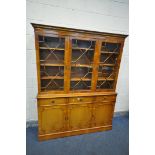 A YEWWOOD TRIPLE DOOR BOOKCASE, with three drawers, width 144cm x depth 32cm x height 184cm x height