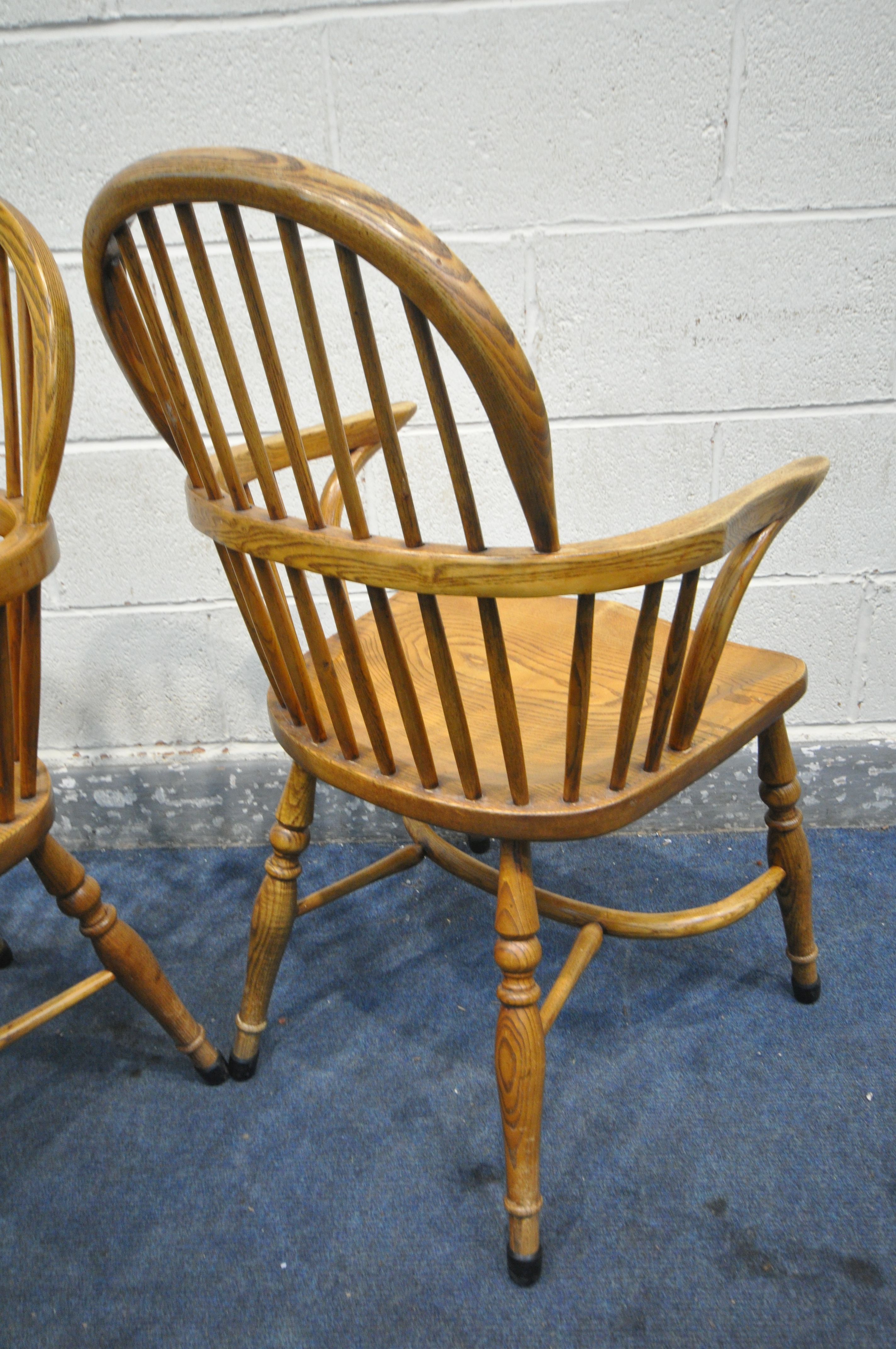 A PAIR OF REPRODUCTION ELM AND ASH WINDSOR AMRCHAIRS, with dish shaped seats (condition:-surface - Image 4 of 4