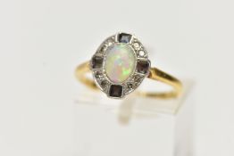 AN EARLY 20TH CENTURY OPAL DRESS RING, oval cabochon opal, within a surround of eight single cut