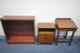 AN OAK SLOPPED SCHOOL DESK, an oak two door cabinet, and a mahogany open bookcase (3)