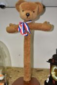 A 'MERRYTHOUGHTS' HAND MADE CHILDREN'S CLOTHES STAND, in the form of a brown teddy bear, height 85cm