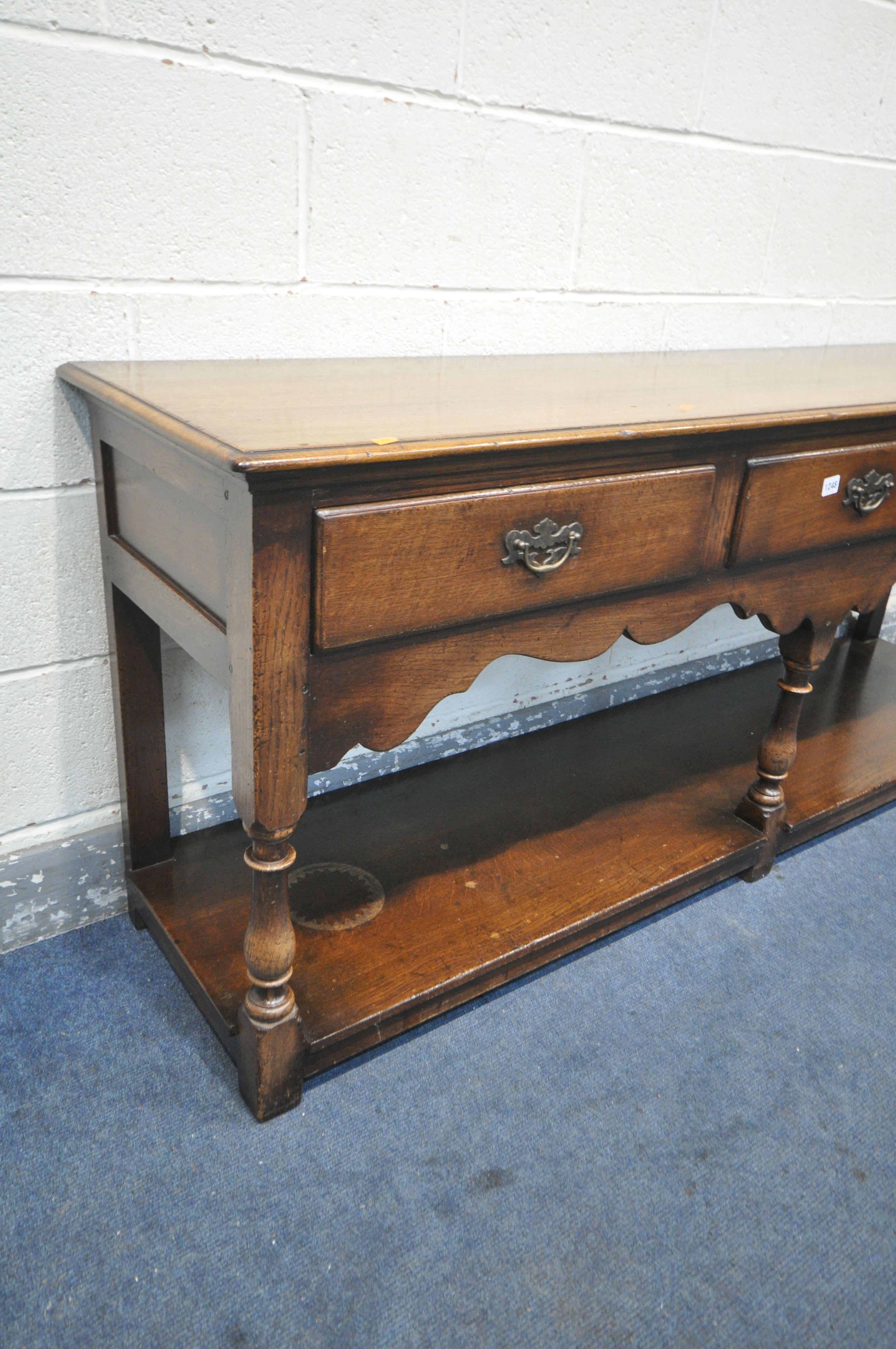 A REPRODUCTION OAK DRESSER BASE, with three frieze drawers, on turned front legs, united by an under - Image 2 of 3